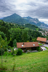 panorama with old farmhouses on the hill named Rhomberg, with view over Dornbirn and Rhein valley,...