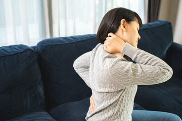 Young woman has problem with structural posture back neck and shoulder pain. Massaged her neck and...