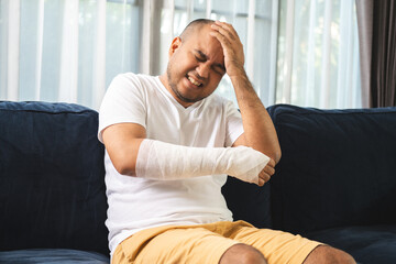 Social security and health insurance concept. Young Man suffer pain from accident fracture broken...