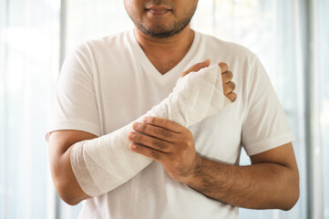 Social security and health insurance concept. Young Man suffer pain from accident fracture broken...