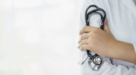 health care concept. Doctor with stethoscope in hand standing in hospital