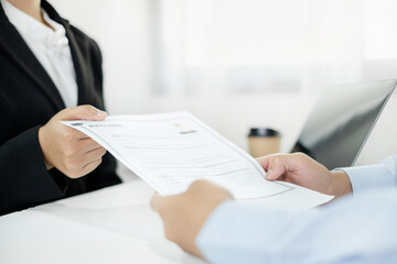 Business people hold a resume and talk to job applicants for job interviews about careers and Their personal history in the company. Employment and Recruitment concepts