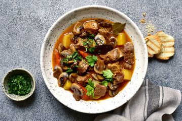 Meat stew ( beef bourguignon ) with vegetable and mushrooms. Top view with copy space.