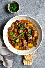 Meat stew ( beef bourguignon ) with vegetable and mushrooms. Top view with copy space. - obrazy, fototapety, plakaty