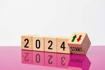 Year 2024 start, Green and red arrow symbol, Year 2023 and finish text reflecting in glass, Beautiful fuchsia and white background, Concept, market analysis, financial value,
