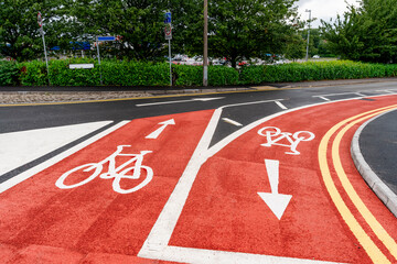 New cycling path made of red asphalt as part of 10 minutes city development plan.
