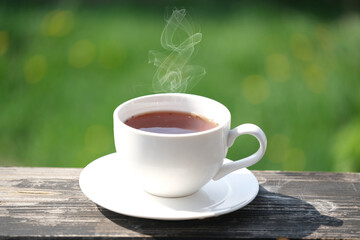 White cup of hot tea or coffee at the terrace or balcony  outdoor.