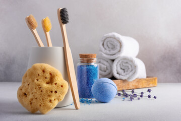 Eco-friendly bathroom accessories: bamboo toothbrushes, natural sea sponge and bath salt