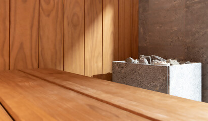 Modern sauna Steam room Interior , wooden shelves, wooden walls, modern stone sauna stove.