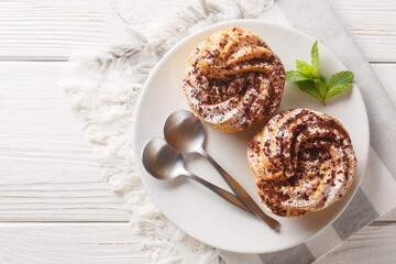 Classic French cake Paris Brest from choux pastry with cream decorated with powdered sugar and...