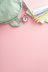 Stationery bliss for the new school season. Vertical top view photo with a sage backpack, pens,...