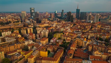 milan city aerial view drone of business district porta nuova at sunrise,skyscrapers with mountain...