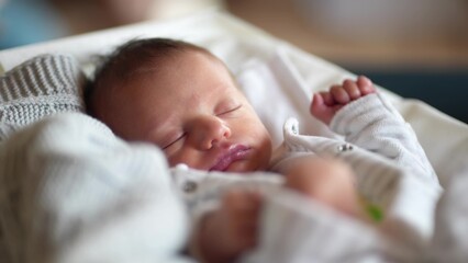 newborn baby sleep. boy infant sleep lies in a child bed. happy family birthday closeup baby...