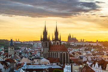 The cityscape of Prague and the Church of Our Lady before Tyn and Prague castle in a summer sunset.