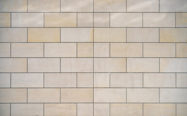 texture of a tiled beige stone wall as background
