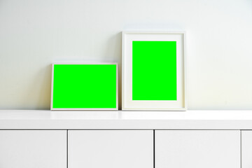 blank picture frames on a sideboard