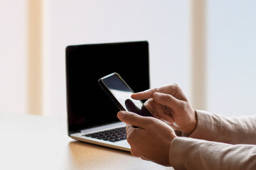 A man works on a laptop and phone. copy space. Businessman, manager, IT specialist, support service