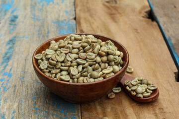 Green coffee beans in a wooden bowl 