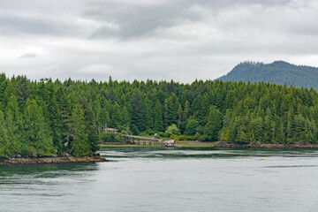 Pacific ocean bay overview with residential house on the shore