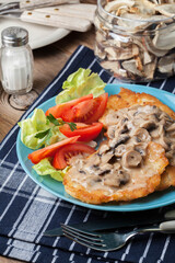 Crispy fried homemade potato pancakes with mushroom sauce.