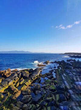 The front view in the morning sky is bright blue with clear white clouds. And the deep indigo of the ocean in broad daylight feeling calm, fresh, relaxing. Gibraltar from Belyounech city in Morocco.