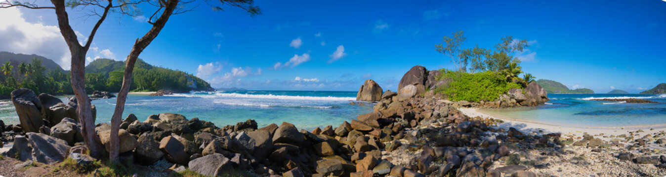 Panorama of port glaud beach, white sandy beach, granite stones and turquoise water, Mahe Seychelles 