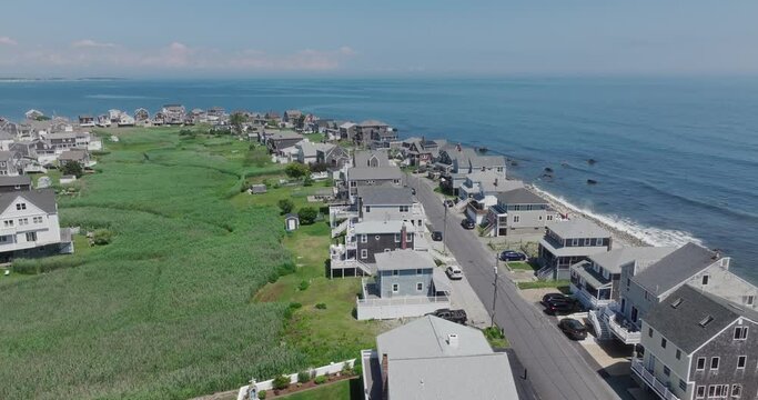 Drone flying by houses at the ocean in scituate at us east coast