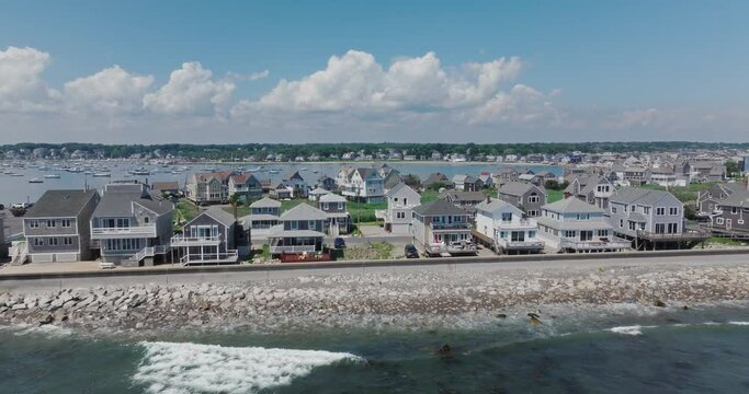 Drone flying by houses at the ocean in scituate at us east coast