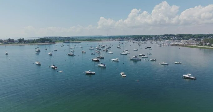 Drone flying over bay with sailboats in scituate at us east coast