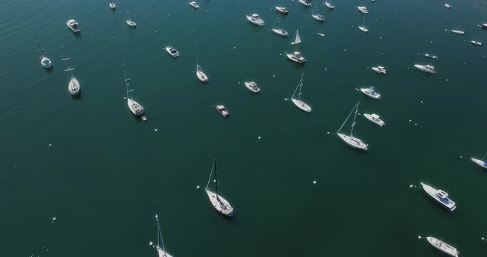 Drone flying over bay with sailboats in scituate at us east coast