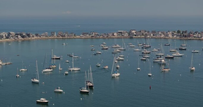 Drone flying over bay with houses and sailboats in scituate at us east coast