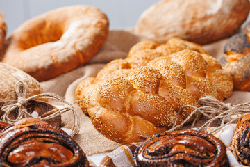 Different types of artisan craft bread in bakery store shelves