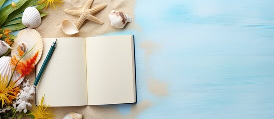 A book for writing with a summer beach theme and accessories, with space to write. Flat lay