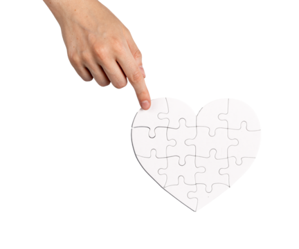 Completing fixing heart shaped puzzle isolated on white background. Love and family psychology concept