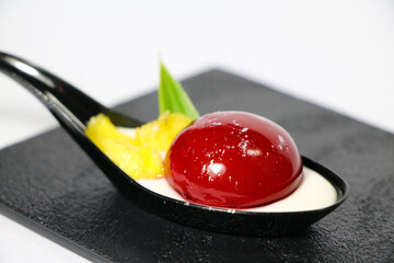 luxury chef signature western fine dining cuisine art fruit berry cherry red pudding jelly in mouse spoon platter on dark background halal dessert pastry beautiful food menu for hotel restaurant