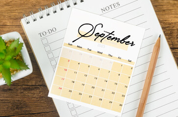 The September 2023 Monthly calendar for 2023 year with wooden pencil.