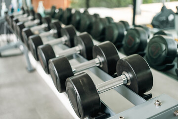 Fototapeta premium Row of Dumbbell indoor gym. Weight training equipment and bodybuilder concept. Sport club with heavy Weight workout for Muscular.