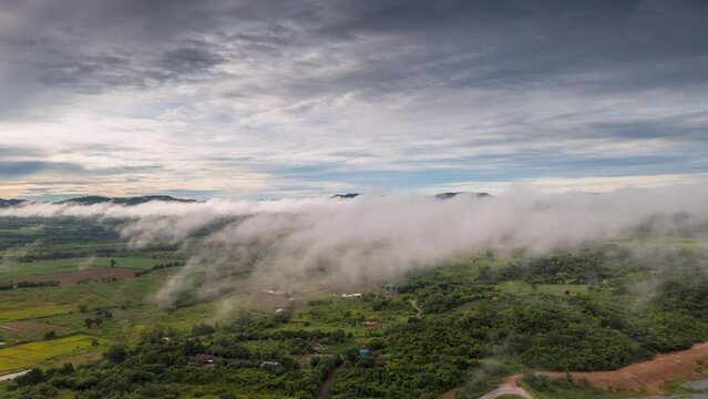 4K motion time lapse video aerial view morning scenery Mist flowing over the high mountains The movement of fog and clouds, Pang Puey, Mae Moh, Lampang, Thailand	