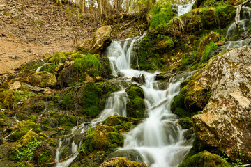 a small waterfall from a spring with velvety water