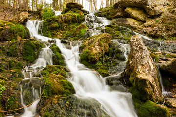 a small waterfall from a spring with velvety water