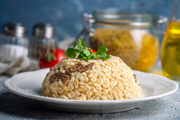 Bulgur pilaf with mushrooms, food concept photo.