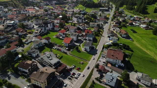 South Tirol village embedded in green mountain landscape from top
