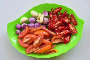 Typical Indonesian kitchen spices consist of pieces tomatoes, onion, garlic, and chilies