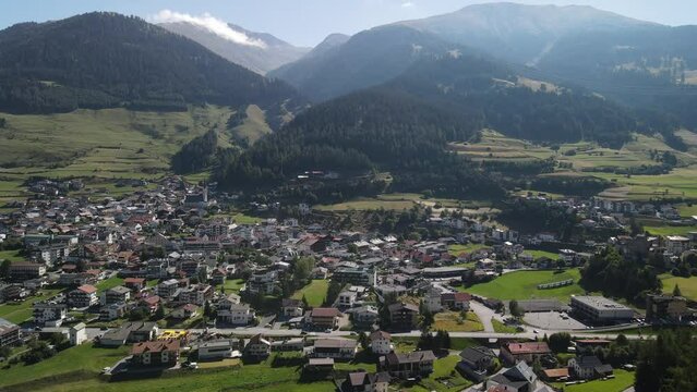 South Tirol village embedded in green mountain landscape from top