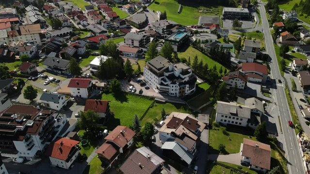 South Tirol village embedded in green mountain landscape from top