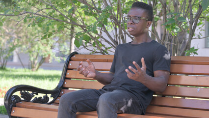 Obraz premium Worried Young African Man Sitting Outdoor Feeling Scared and Afraid