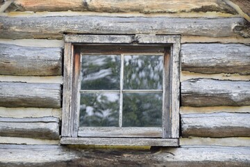 old wooden 4 pane window in the log home