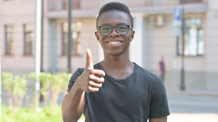 Outdoor Portrait of Young African Man Doing Thumbs Up