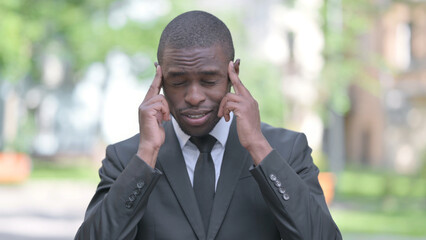 Outdoor Portrait of Tired African Businessman with Headache