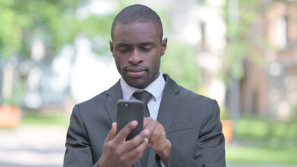 Outdoor Portrait of African American Man Using Smartphone